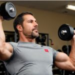 man lifting dumbbell